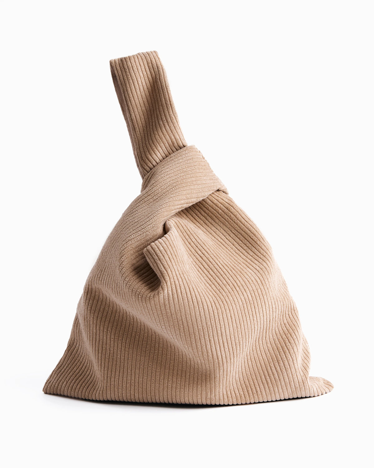 Beige corduroy Hazel Bag knot bag standing upright on a white background