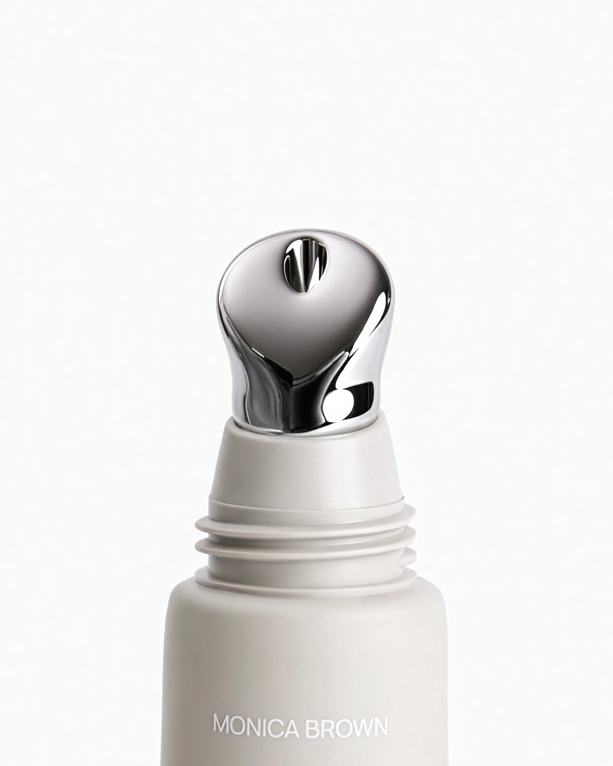 Close-up lib balm tube with opened cap, metal applicator